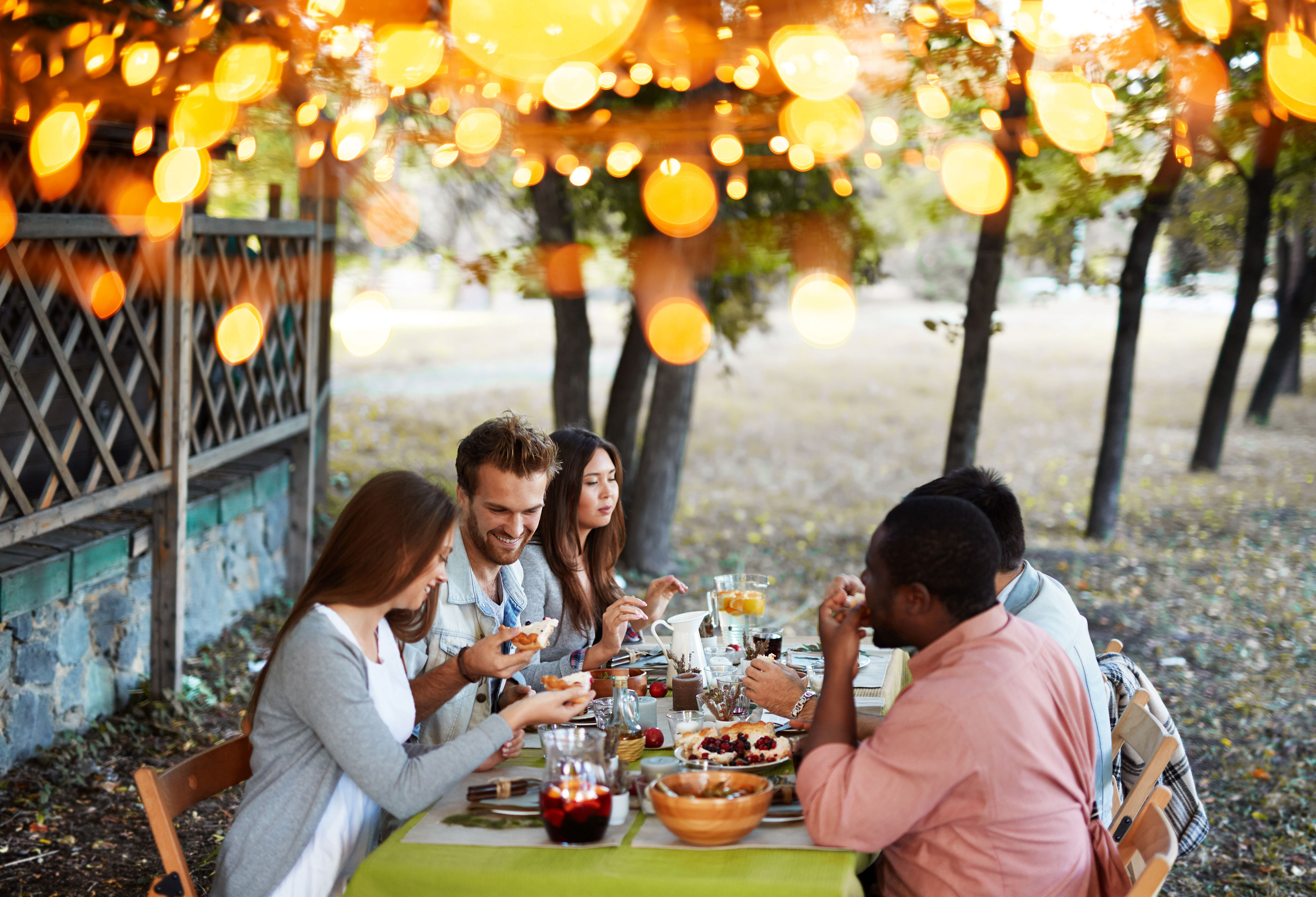 Friends sharing food around an outdoor table